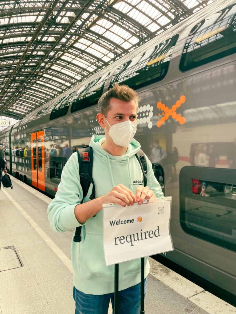 Dominik welcoming the team at the station with a required sign in his hand