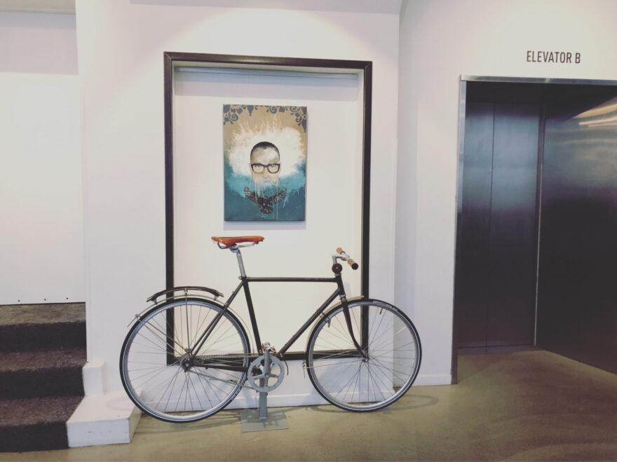 a bike in front of a painted portrait