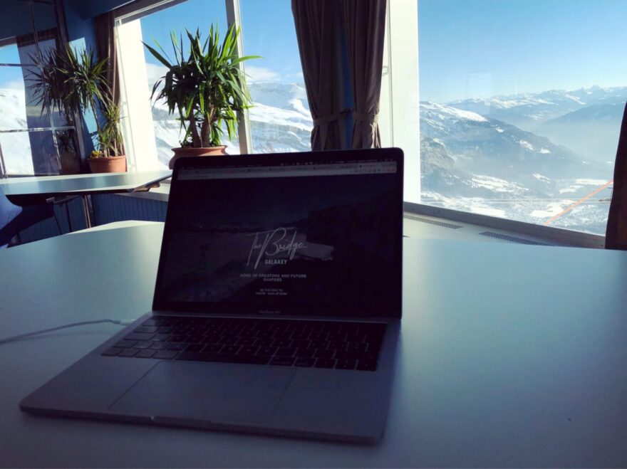 Photo of Karin's laptop with a view of the mountains behind it