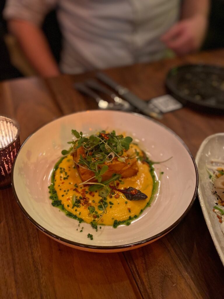 a bowl of food on a plate on a table
