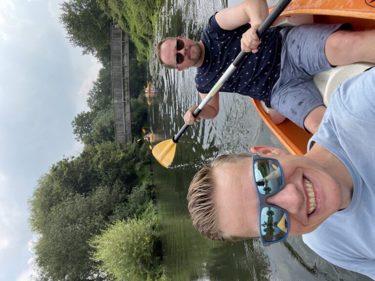 Paschi and Velthy paddling in a kayak on the water