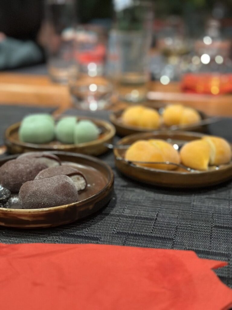 Mochi in verschiedenen Farben serviert auf verschiedenen Tellern