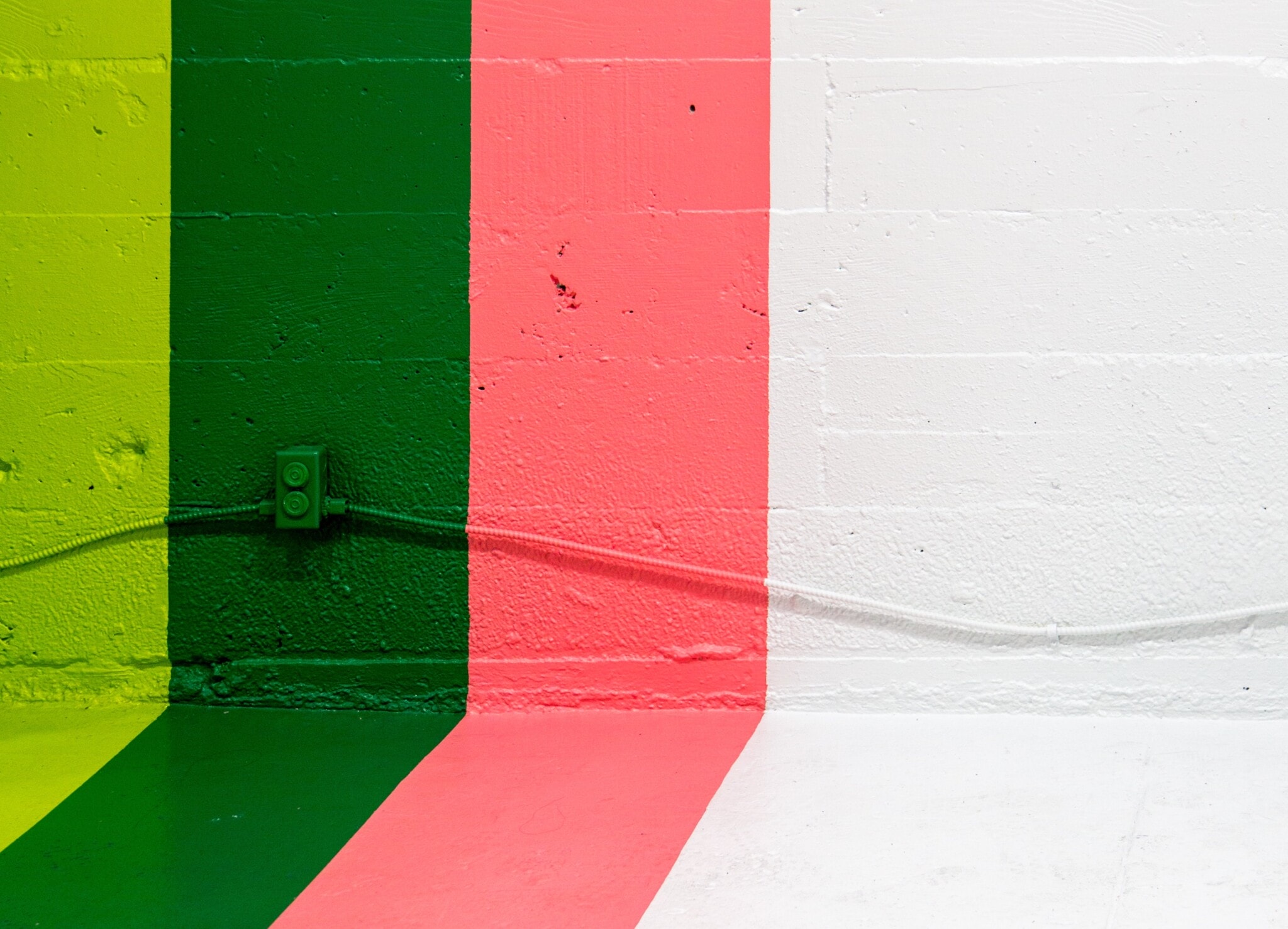 One wall in the colors light green, green, salmon-pink and white