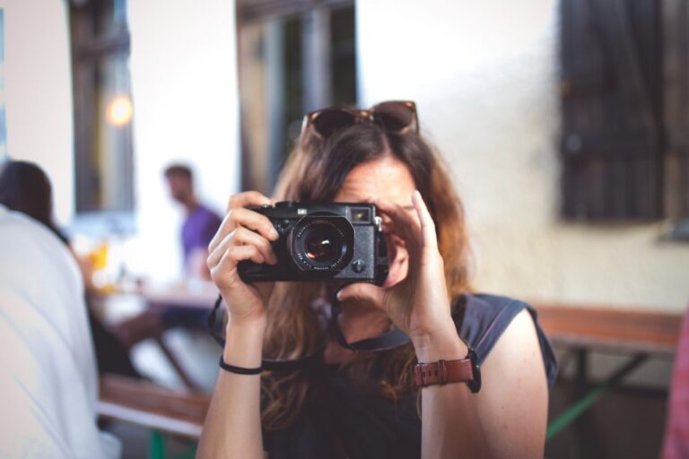 Photo of Karin holding a camera in front of her face to take a photo