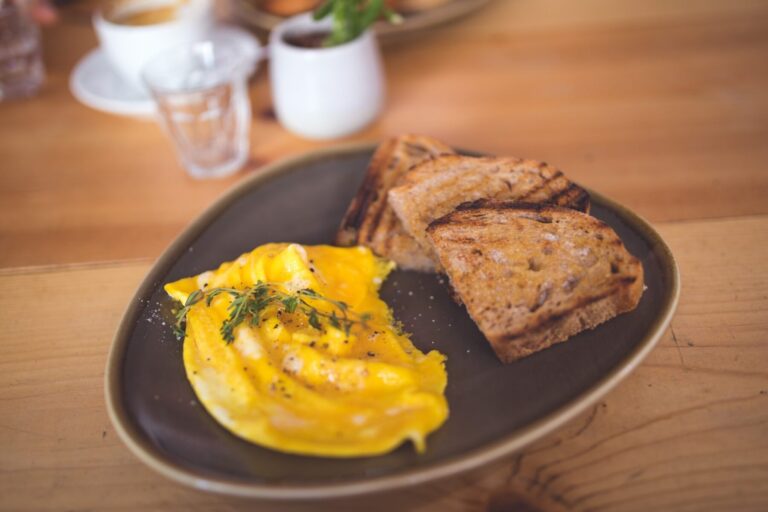 Photo of scrambled eggs with bread prepared on a plate