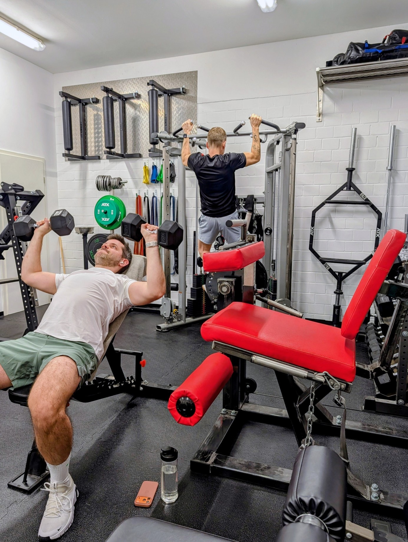 Paschi and Dominik train together in the fitness room during the retreat.