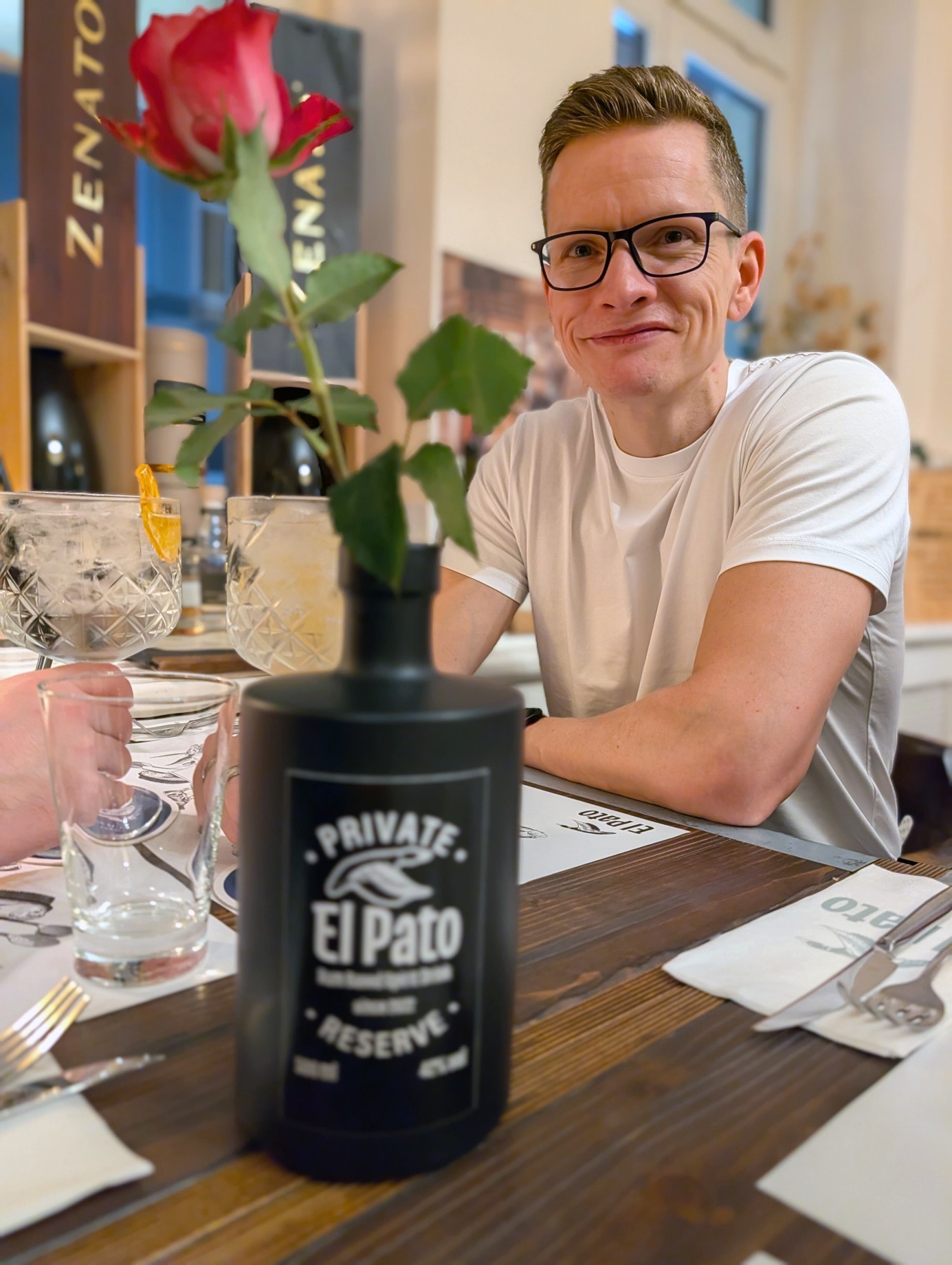 Paschi sits at the dining table in the El Pato restaurant during Christmas dinner.